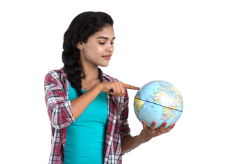 young woman holding the world globe and posing on a white background.
