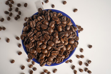 coffee beans in a white glass on a white background, Top view
