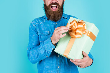 surprise for him. shopping and sale. mature brutal hipster with present. buy in mall. happy bearded...