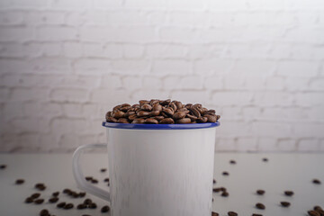 coffee beans in white glass white brick background scene