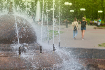 Hot summer in the city.Fountain in the city in the foreground.