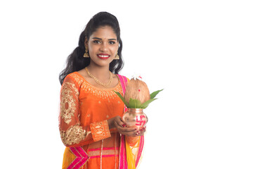 Indian Woman holding a traditional copper kalash, Indian Festival, copper kalash with coconut and...