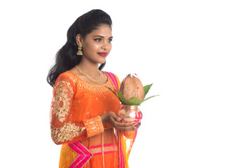 Indian Woman holding a traditional copper kalash, Indian Festival, copper kalash with coconut and...