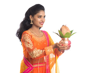 Indian Woman holding a traditional copper kalash, Indian Festival, copper kalash with coconut and...