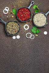 Obraz na płótnie Canvas Assortment of aromatic spices and herbs on dark rustic background with copy space for your text. Cook book cover template. Vertical image.
