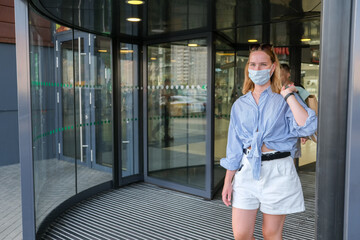 girl in a medical shop buys clothes in covid 19. The opening of stores after quarantine. Promotions, sale discounts on black Friday, cyber Monday. Shopping in a mask, respirator.Shopping offline real