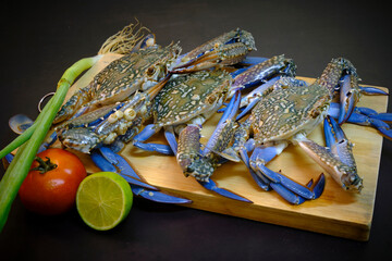 Colorful  sea crab on bamboo chopping board, ready to cook.