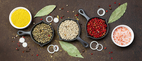 Set of different aromatic spices on brown rustic background close up. Healthy food concept.