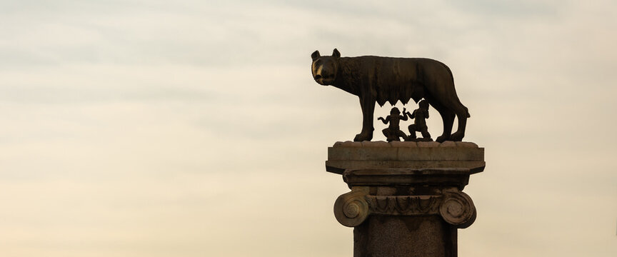 The statue of the Capitoline Wolf with Romulus and Remus and the Coliseum in background, Rome, Italy