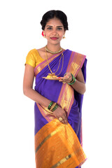 Indian woman performing worship, portrait of a beautiful young lady with pooja thali isolated on...