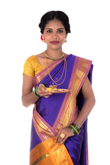 Indian woman performing worship, portrait of a beautiful young lady with pooja thali isolated on...