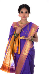 Indian woman performing worship, portrait of a beautiful young lady with pooja thali isolated on...