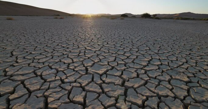 Climate change.Aerial fly over view of patterned cracked mud surface of a dry dam due to drought from climate change and global warming