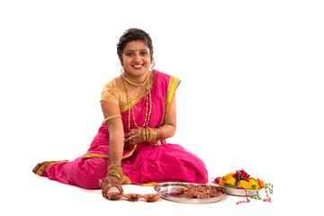 Portrait of a Indian Traditional Girl holding diya, Diwali or deepavali photo with female hands...