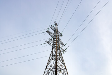 High voltage power line on industrial electricity line tower. Energy transmisson with overhead...