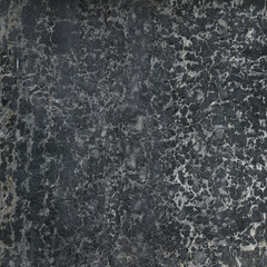 Close up of a dark and old marble surface