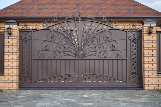 Luxury metal wrought side sliding gates with ornate elements.