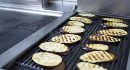 Eggplant grilled on cast iron griddle. Concept of organic and healthy food preparation