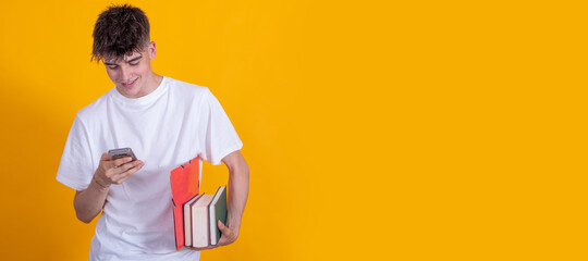 teenage student with mobile phone and books isolated on color background