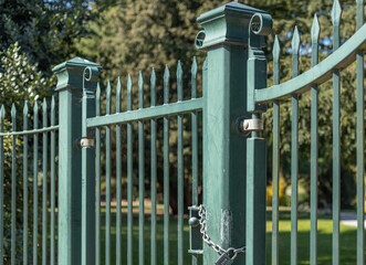 Green railings with a gate which is locked