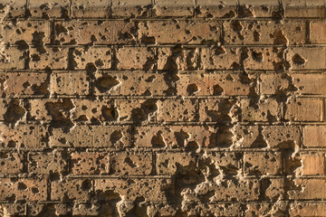 Brick wall of Twierdza Modlin near Warsaw Poland with bullet holes. Nostalgic about war.