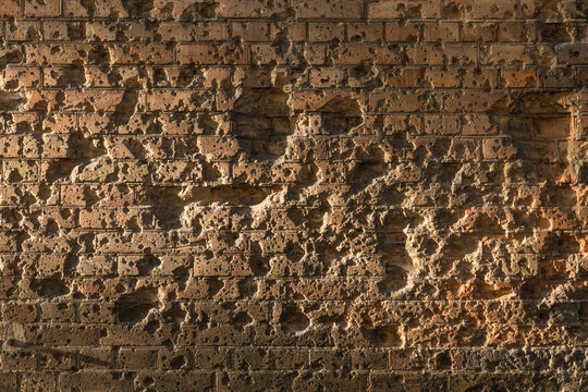 Brick wall of Twierdza Modlin near Warsaw Poland with bullet holes. Nostalgic about war.