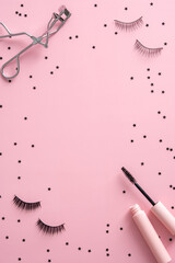 Frame of mascara, false eyelashes, curler and confetti on pink background. Beauty blog banner mockup