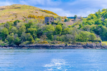 Fototapeta na wymiar A view from a boat on the Firth of Lorn towards Dunollie Castle at Oban, Scotland on a summers day
