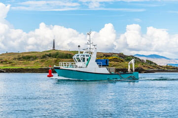 A view of a fishing boat entering Oban Bay, Oban, Scotland on a summers day