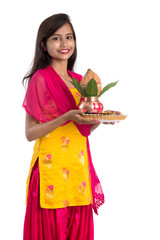 Indian girl holding a traditional copper Kalash with Pooja Thali, Indian Festival, copper Kalash...