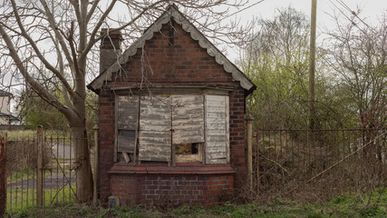 Fototapeta na wymiar Small house with boared up windows