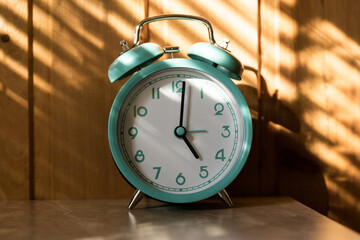 Old clock isolated on wooden background with space for text. Concept of time