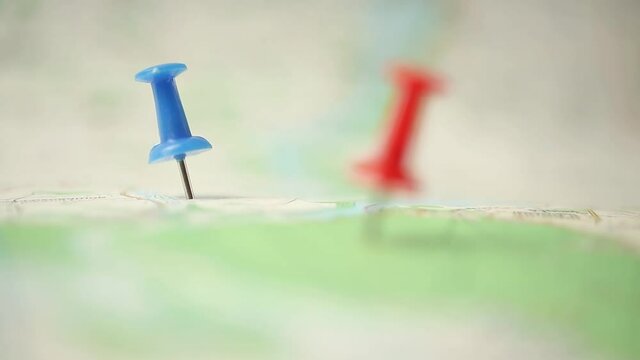 Travel concept with pin color pushpins on the map, selective focus footage