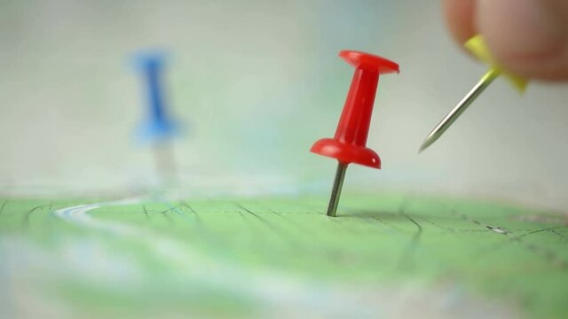 Man pinned the travel map, close-up footage 