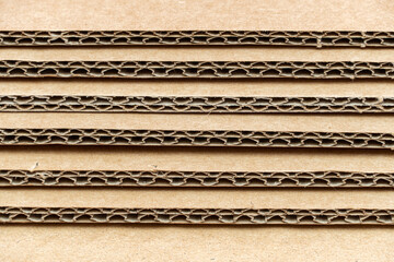 Stack of cardboard for packaging with cells close up as background