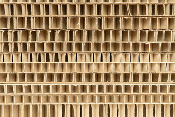 cut of honeycomb cardboard pack stack with large cells close-up as a background - obrazy, fototapety, plakaty