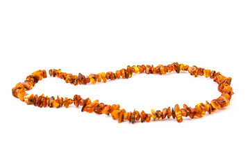 Baltic necklace made of Natural polished transparent honey luxury amber beads with inclusions on white. close up selective soft focus. Space for text