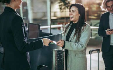 Businesswoman doing flight check in at airport