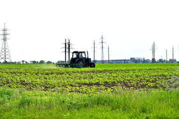 landscape, tractor in the field at agricultural work