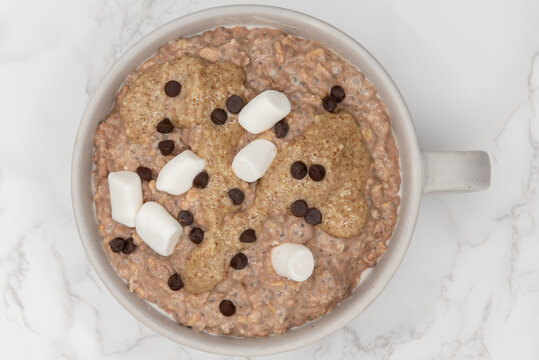 Marshmellows And Chocolate Chips On Top Of Oatmeal Ready To Eat In A Bowl On The Table Is A Great Way To Start The Day With A Good Source Of Fiber And Protein.