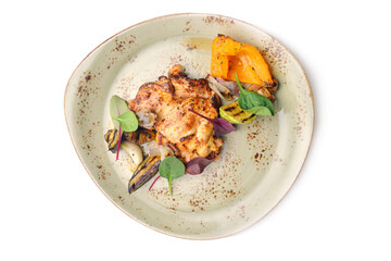 Grilled chicken with vegetables on white plate.top view