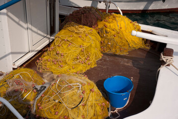 Astros Port, Peloponnese, Greece - June 24, 2021: Fishing nets drying at a picturesque fishing port.