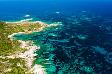 Fototapeta na wymiar qView from above, stunning aerial view of a rocky coastline bathed by a beautiful turquoise sea. Costa Smeralda, Sardinia, Italy.