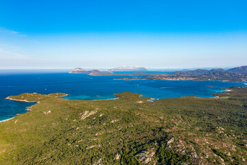 View from above, stunning aerial view of a green coastline with some beaches bathed by a turquoise sea. Liscia Ruja,Sardinia, Italy.