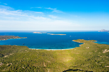 Fototapeta na wymiar View from above, stunning aerial view of a green coastline with some beaches bathed by a turquoise sea. Liscia Ruja, Costa Smeralda, Sardinia, Italy.