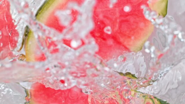 Super Slow Motion Shot of Melon Slices Falling Into Water Whirl at 1000 fps.