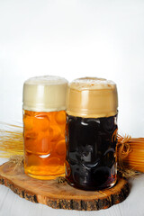 two Glasses of light and dark beer with decorations and place for text