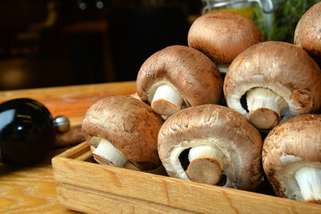 brown mushrooms Fresh champignon mushrooms on wooden table, closeup. Space for text