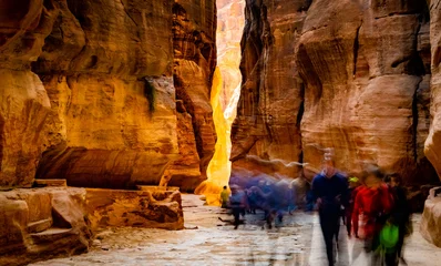 Fotobehang Group of people between sandstone rocks at narrow path in Petra, Jordan © Ievgen Skrypko