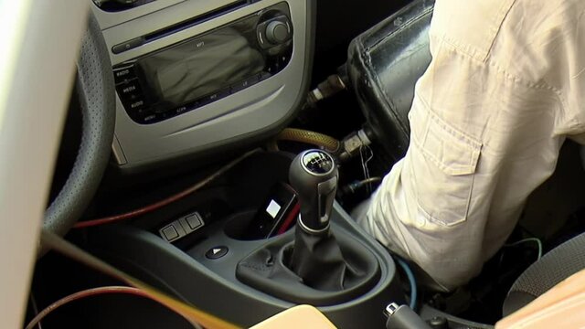 Technician preparing a Car for a Crash-test at the Laboratory. Close Up. 